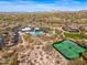 An aerial view features a community pool, the clubhouse, and surrounding desert landscaping at 9270 E Thompson Peak Pkwy # 367, Scottsdale, AZ 85255
