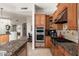 A kitchen with stainless steel appliances, custom cabinets, and a granite countertop island at 9270 E Thompson Peak Pkwy # 367, Scottsdale, AZ 85255