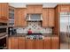 The kitchen has custom cabinets, stainless steel appliances, and a tile backsplash behind the stove at 9270 E Thompson Peak Pkwy # 367, Scottsdale, AZ 85255