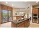 This kitchen includes a granite island, stainless steel appliances, and beautiful cabinetry at 9270 E Thompson Peak Pkwy # 367, Scottsdale, AZ 85255