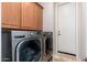 This laundry room features a washer, dryer and plenty of cabinet space for storage at 9270 E Thompson Peak Pkwy # 367, Scottsdale, AZ 85255
