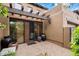 Brick patio with stucco walls, potted plants, and glass doors leading inside at 9270 E Thompson Peak Pkwy # 367, Scottsdale, AZ 85255