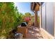 Charming outdoor kitchen area with a built-in grill and patio space, surrounded by lush greenery at 9270 E Thompson Peak Pkwy # 367, Scottsdale, AZ 85255