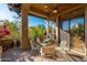 Inviting covered patio with ceiling fan, stylish furniture, and natural light offering a comfortable outdoor living space at 9270 E Thompson Peak Pkwy # 367, Scottsdale, AZ 85255