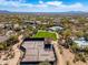 Aerial view of the community tennis courts surrounded by lush greenery and desert landscape at 9270 E Thompson Peak Pkwy # 367, Scottsdale, AZ 85255