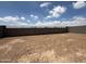 Unfinished, expansive backyard enclosed by block fencing, ready for landscaping at 9539 W Parkway Dr, Tolleson, AZ 85353