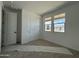 Bright bedroom featuring two windows and a closet with sliding doors, creating a cozy and inviting atmosphere at 9539 W Parkway Dr, Tolleson, AZ 85353