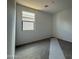 A simple and clean bedroom with neutral colors, carpet, and a window offering ample natural light at 9539 W Parkway Dr, Tolleson, AZ 85353