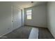 A view of a well-lit bedroom featuring sliding closet doors and a window offering ample natural light at 9539 W Parkway Dr, Tolleson, AZ 85353