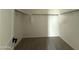 Walk-in closet with carpeted floors and white shelving at 9539 W Parkway Dr, Tolleson, AZ 85353