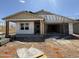 Exterior home under construction featuring a two-car garage and covered entry at 9539 W Parkway Dr, Tolleson, AZ 85353