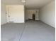 Spacious two car garage with painted walls and concrete flooring at 9539 W Parkway Dr, Tolleson, AZ 85353