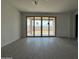 View of the living room with sliding glass doors that lead to an outdoor patio at 9539 W Parkway Dr, Tolleson, AZ 85353