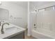 Clean bathroom featuring a double sink vanity and a bathtub with white tile surround at 9740 E Baltimore Cir, Mesa, AZ 85207