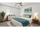 Comfortable bedroom with ceiling fan, natural light, and stylish staging at 9740 E Baltimore Cir, Mesa, AZ 85207