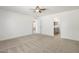 Spacious bedroom with neutral carpet and modern ceiling fan, leading to bathroom and additional room at 9740 E Baltimore Cir, Mesa, AZ 85207