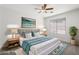 Staged main bedroom with natural light, ceiling fan, and stylish décor at 9740 E Baltimore Cir, Mesa, AZ 85207