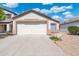Attached two car garage with a concrete driveway and neutral colored exterior at 9740 E Baltimore Cir, Mesa, AZ 85207