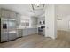 Renovated kitchen featuring stainless steel appliances, light gray cabinets, and wood-look floors at 9740 E Baltimore Cir, Mesa, AZ 85207