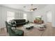 Bright living room with modern furniture, a ceiling fan, and ample natural light at 9740 E Baltimore Cir, Mesa, AZ 85207