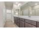 Ensuite bathroom with double sink vanity, framed mirror, and access to walk-in closet and shower at 10229 N 49Th Dr, Glendale, AZ 85302