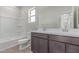 Bathroom featuring a double sink vanity and shower over tub with tile flooring at 10229 N 49Th Dr, Glendale, AZ 85302