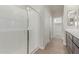 Primary bathroom featuring a clear glass shower enclosure, walk-in closet and double sink vanity at 10229 N 49Th Dr, Glendale, AZ 85302