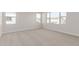 Bright bedroom with large windows offering neighborhood views and neutral carpet at 10229 N 49Th Dr, Glendale, AZ 85302