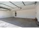 A spacious garage featuring a large concrete floor and white walls at 10229 N 49Th Dr, Glendale, AZ 85302