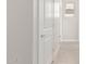 Bright hallway featuring wood-look tile flooring, white walls, and neutral trim at 10229 N 49Th Dr, Glendale, AZ 85302