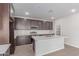 Modern kitchen with stainless steel appliances, dark cabinets, and quartz countertops on the kitchen island at 10229 N 49Th Dr, Glendale, AZ 85302