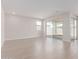 Open-concept living room with wood-look tile floors and sliding glass doors at 10229 N 49Th Dr, Glendale, AZ 85302