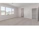 Bright primary bedroom with neighborhood views, ensuite access, and neutral carpet at 10229 N 49Th Dr, Glendale, AZ 85302