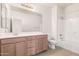 A well-lit bathroom featuring a shower-tub combo, vanity, and tile flooring, offering a clean and functional space at 1176 N 169Th Ave, Goodyear, AZ 85338