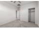 Bright bedroom with neutral carpeting, ceiling fan and closet at 1176 N 169Th Ave, Goodyear, AZ 85338