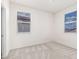 A bright bedroom featuring neutral carpet and walls, with natural light coming through the windows at 1176 N 169Th Ave, Goodyear, AZ 85338
