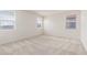 Bright bedroom with neutral carpeting, three windows, and ample natural light at 1176 N 169Th Ave, Goodyear, AZ 85338