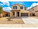 Charming two-story home featuring a two-car garage and low-maintenance desert landscaping in the front yard at 1176 N 169Th Ave, Goodyear, AZ 85338