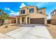 Attractive two-story home with a spacious driveway, desert landscaping, and classic architectural details at 1176 N 169Th Ave, Goodyear, AZ 85338