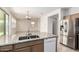 Open kitchen featuring granite countertops, stainless steel appliances, and a seamless connection to the living area at 1176 N 169Th Ave, Goodyear, AZ 85338