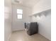 Convenient laundry room with modern washer and dryer, plus shelving for efficient storage solutions at 1176 N 169Th Ave, Goodyear, AZ 85338