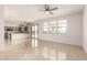 Bright and open living area with tile flooring, patio access, and a view of the modern kitchen at 1176 N 169Th Ave, Goodyear, AZ 85338
