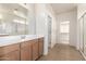 Bathroom featuring double sinks, large mirrors, and a glass-enclosed shower at 1176 N 169Th Ave, Goodyear, AZ 85338