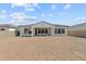 The exterior rear of the home showing the covered patio and backyard at 12327 W Luxton Ln, Avondale, AZ 85323
