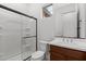 Bathroom features a shower with glass doors and a vanity with storage at 12327 W Luxton Ln, Avondale, AZ 85323