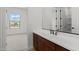 Bathroom featuring a large mirror, vanity with storage, and an open doorway to a bedroom at 12327 W Luxton Ln, Avondale, AZ 85323