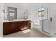 Bathroom with dual sinks, granite countertops, soaking tub, and a separate glass shower at 12327 W Luxton Ln, Avondale, AZ 85323