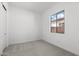 Bedroom featuring neutral gray carpet, white walls, and a window for natural light at 12327 W Luxton Ln, Avondale, AZ 85323