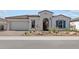 Charming single-story home with stucco exterior, landscaped yard, and inviting arched entryway at 12327 W Luxton Ln, Avondale, AZ 85323