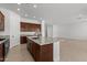 Spacious kitchen featuring a center island and tiled floors at 12327 W Luxton Ln, Avondale, AZ 85323
